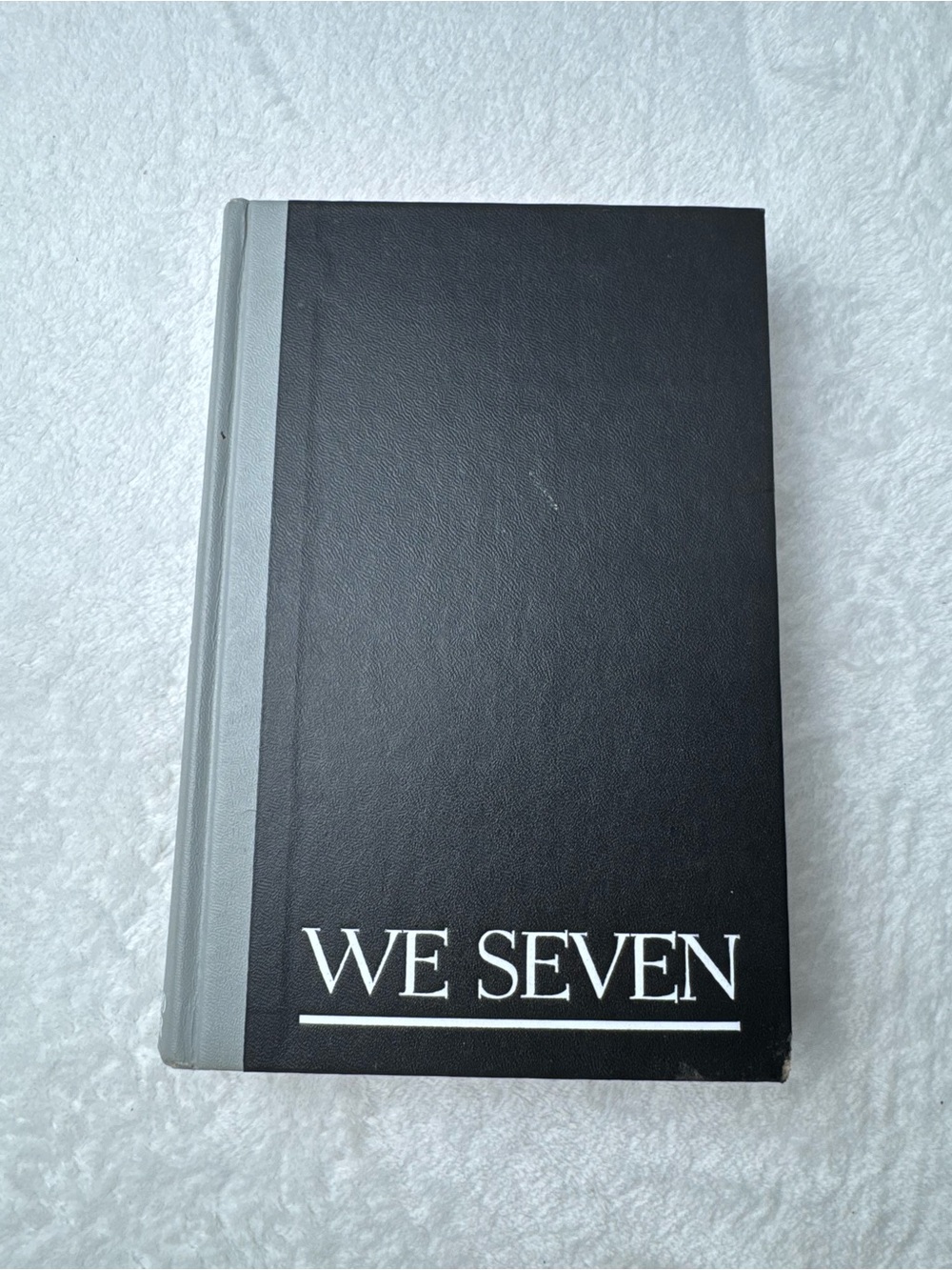WE SEVEN Black Hardcover Book